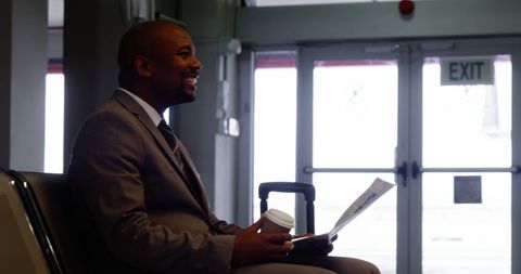 Business Traveler Enjoying Coffee and Newspaper at Airport