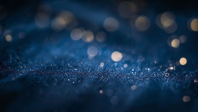 Shimmering Indigo Textile Band Sparkling with Glitter and Warm Bokeh Lights