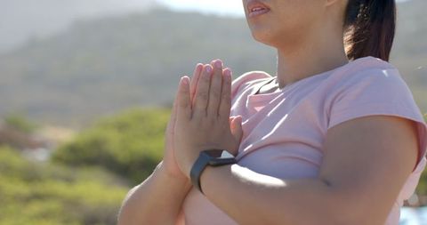 Woman Practicing Yoga on Mountain Hike with Smartwatch