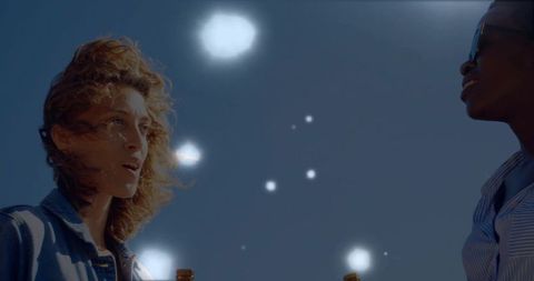 Friends Celebrating and Chatting Under Glowing Dusk Sky