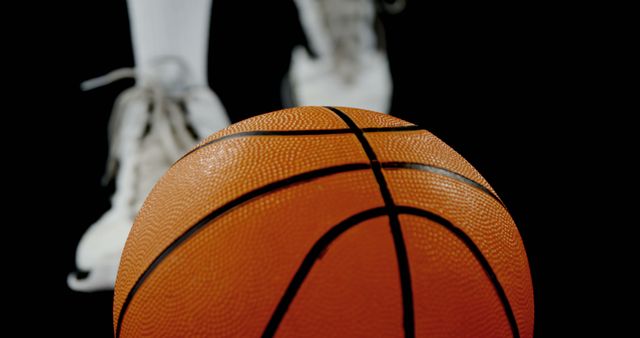 Close-up of Basketball with Player in Background on Court - Download Free Stock Images Pikwizard.com