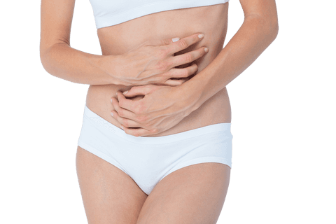 Woman in pain holding stomach against clear background