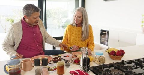 Senior Couple Preparing Healthy Breakfast Together at Clean Kitchen