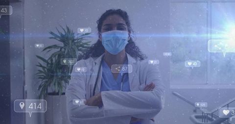 Confident masked clinician standing arms crossed in modern exam room with digital icons