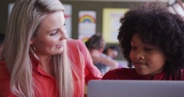 Smiling Teacher Helping Young Student with Laptop in Classroom - Download Free Stock Images Pikwizard.com