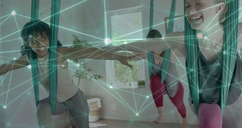 Diverse Women Practicing Aerial Yoga with Digital Connection Overlay