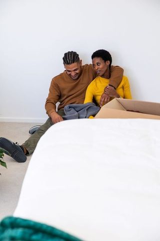 Couple relaxing while unpacking in new home