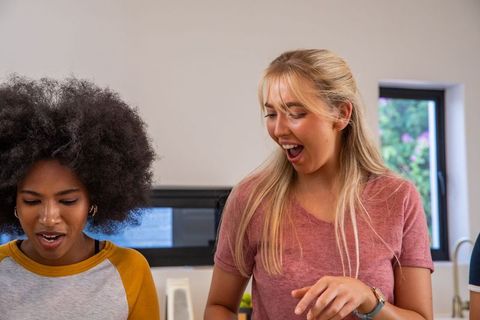 Diverse Friends Expressing Surprise in Bright Home Kitchen