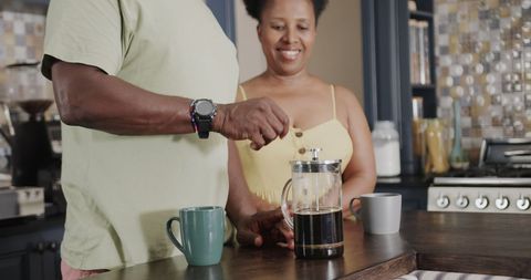 Senior African American Couple Brewing Coffee Together at Kitchen Counter