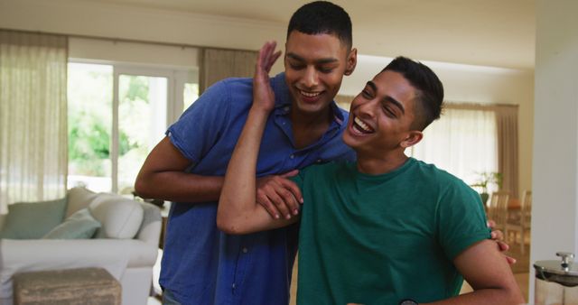 Smiling biracial gay male couple talking and hugging - Download Free Stock Photos Pikwizard.com