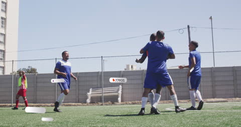 Digital Overlay on Diverse Male Soccer Players Celebrating on Field
