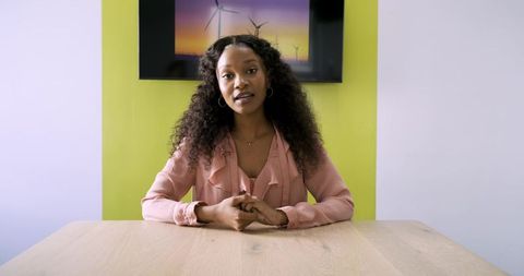 Businesswoman Presenting Green Energy Innovations in Modern Office