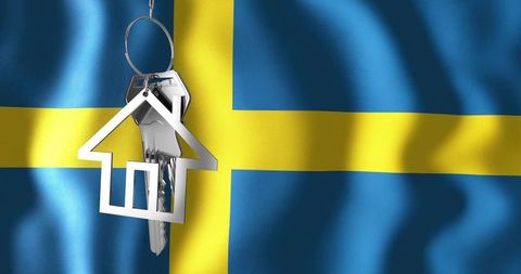 Chrome house keyring with keys over sweden flag symbolizing property market and relocation