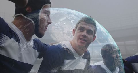 Friends Playing Bubble Soccer with Planet Earth Reflection
