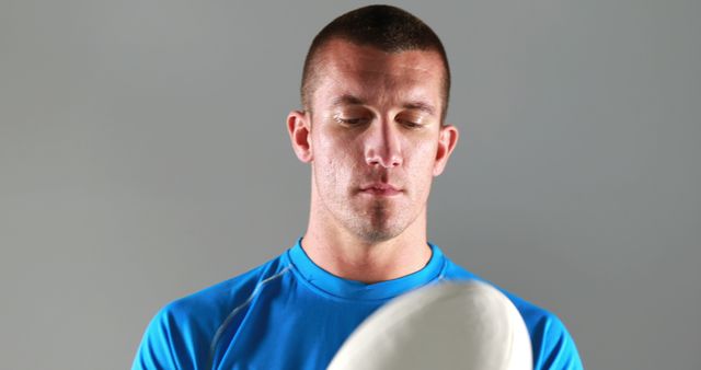 Focused Man Playing with Frisbee on Gray Background - Download Free Stock Images Pikwizard.com