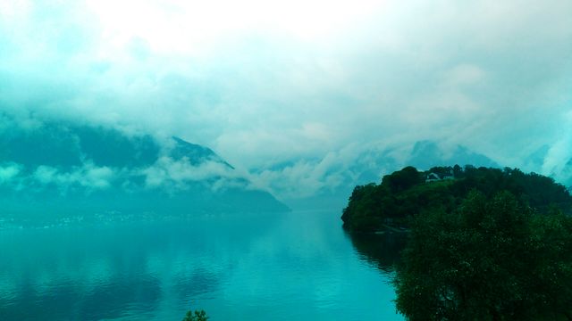 Serene Lake with Cloudy Sky and Hills in Background - Download Free Stock Photos Pikwizard.com