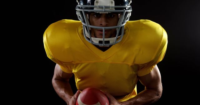 American Football Player in Yellow Jersey Holding Football - Download Free Stock Images Pikwizard.com