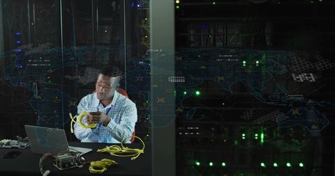 It technician coiling ethernet cables and troubleshooting network hardware in data center