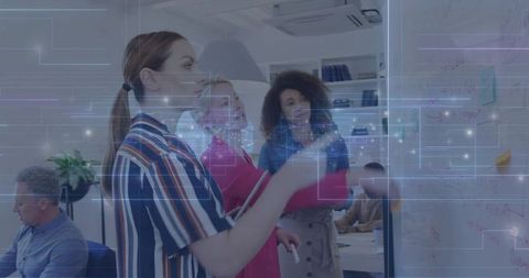 Leading team brainstorming with whiteboard and digital data visualization in modern office