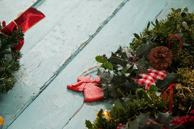 Rustic Christmas Decorations with Fir Wreath on Wooden Planks - Download Free Stock Photos Pikwizard.com