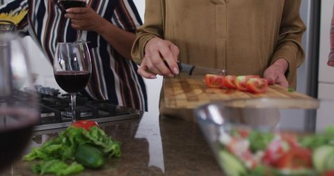 Seniors Enjoying Together Cooking Fresh Meal in Kitchen