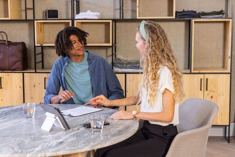 Diverse Coworkers Collaborating Over Documents in Modern Office