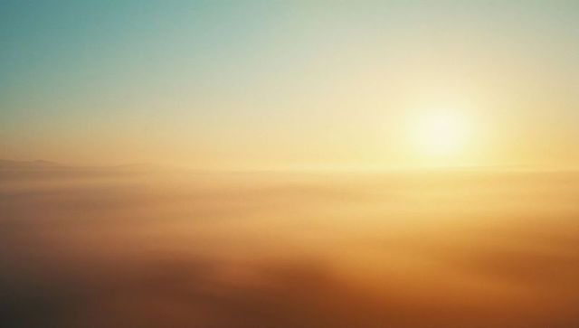 Golden Sunrise Over Misty Clouds at Dawn