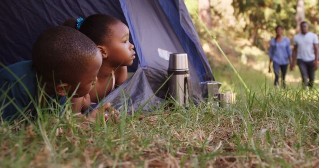 Children Camping in Tent Gazing at Family Walking Near Wilderness - Download Free Stock Images Pikwizard.com