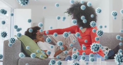 Mother comforting sick child with overlay of virus illustrations