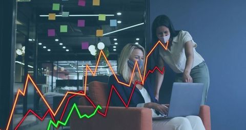 Women Collaborate Using Data Graph in Modern Office