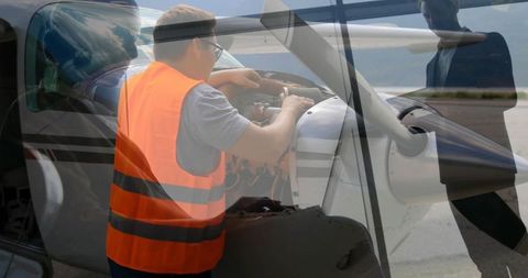 Aviation Engineer Inspecting Aircraft Engine with Observing Crew