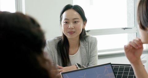 Woman Leading Business Meeting in Modern Office Environment