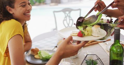 Happy Latina Woman Enjoying Outdoor Meal with Friends - Download Free Stock Images Pikwizard.com