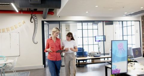 Female Colleagues Collaborating in Modern Open-Plan Office