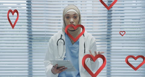 Young Female Doctor with Floating Hearts Holding Digital Tablet