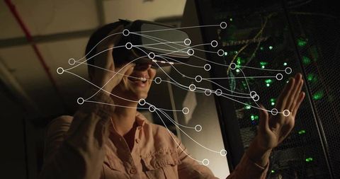 Woman exploring virtual network data in server room with vr headset