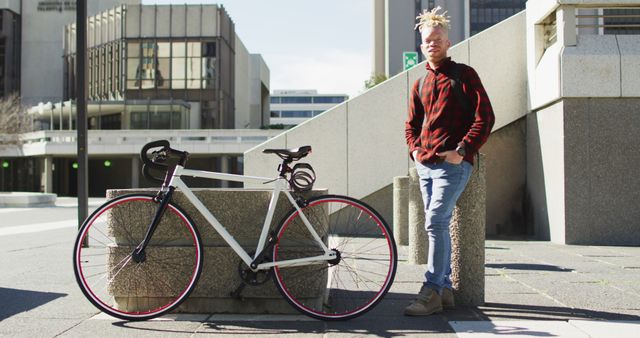 Urban cyclist taking break next to bicycle in modern city environment - Download Free Stock Images Pikwizard.com