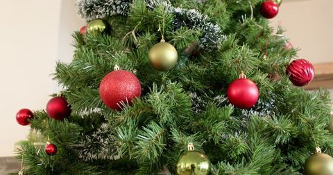 Festive Artificial Christmas Tree with Vibrant Red and Green Baubles