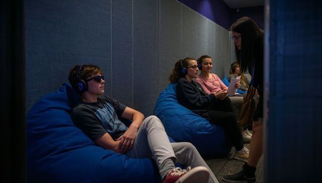 Teenagers engaged in modern learning environment with technology