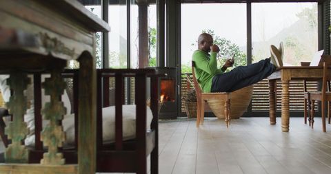 Senior Man Relaxing with Smartphone at Natural Light Dining Room - Download Free Stock Images Pikwizard.com