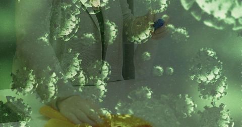 Person disinfecting surface with virus overlay symbolizing health and safety
