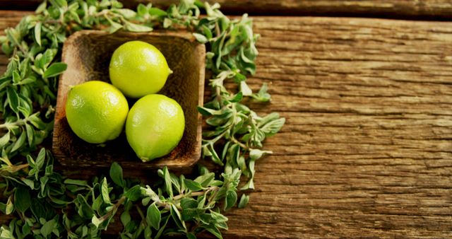 Fresh Limes in Wooden Bowl with Green Herbs on Rustic Wooden Surface - Download Free Stock Images Pikwizard.com