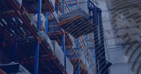 Reach forklift lifting wrapped pallet to upper rack in highbay warehouse