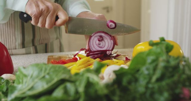 Senior Man Slicing Onion in a Modern Kitchen - Download Free Stock Images Pikwizard.com