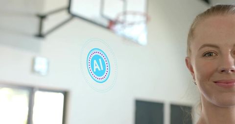 Female athlete standing in indoor basketball court smiling with futuristic ai interface