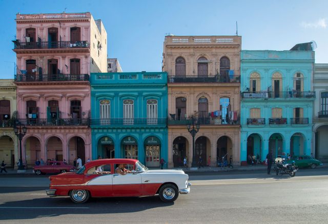 Vintage Car Driving Past Colorful Colonial Buildings in Havana - Download Free Stock Photos Pikwizard.com