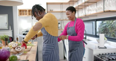 African American Couple Enjoying Cooking Together at Home
