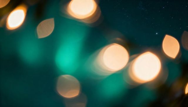 Glowing teal and amber bokeh lights shimmering over starry night sky for dreamy backdrops