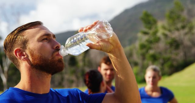 Refreshing Hydration Break During Outdoor Group Exercise - Download Free Stock Images Pikwizard.com