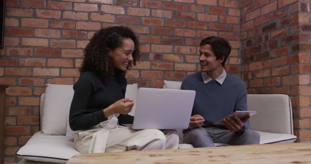 Colleagues Sharing Ideas on Laptops in Modern Brick Office - Download Free Stock Images Pikwizard.com